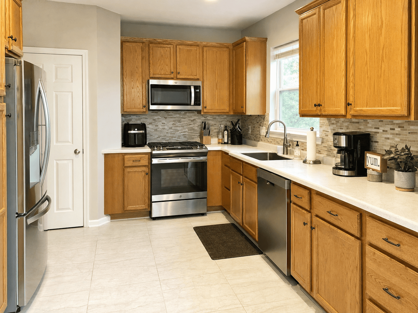 Clean residential kitchen with natural wood cabinets